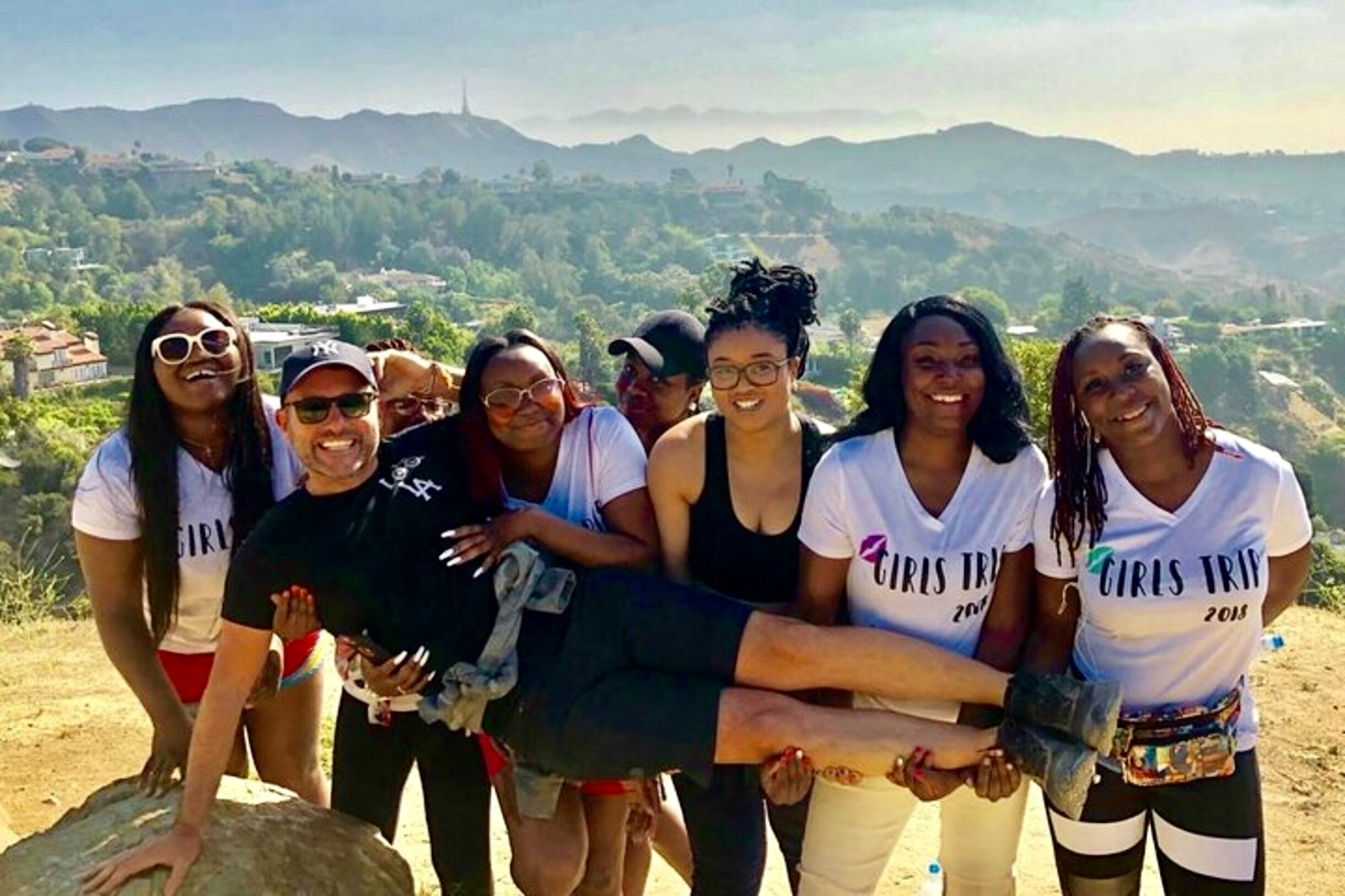 A group of girls holding up their guide on the Hollywood Sign Hike