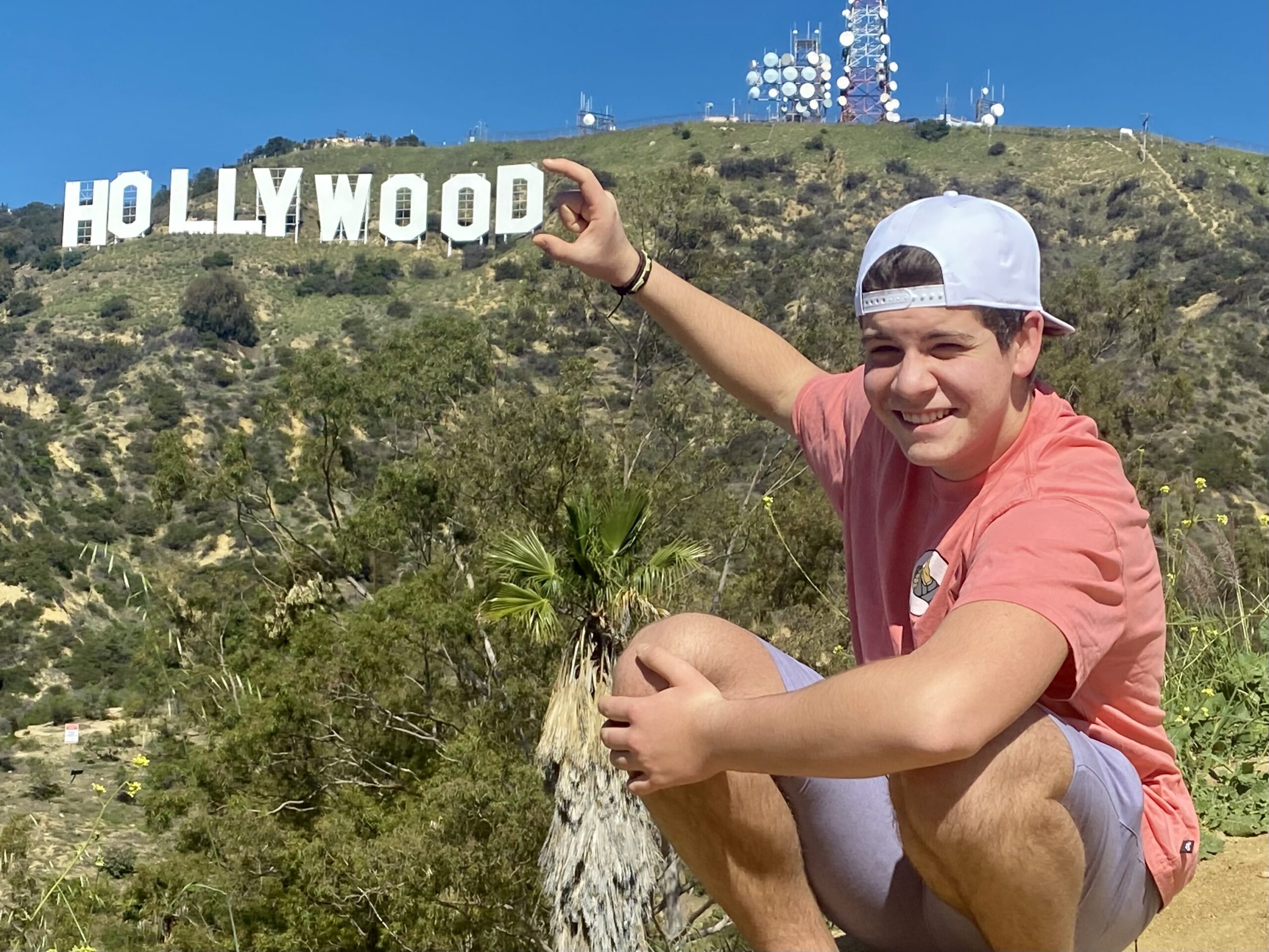 A guest on the Hollywood Sign Hike pinches the Hollywood Sign