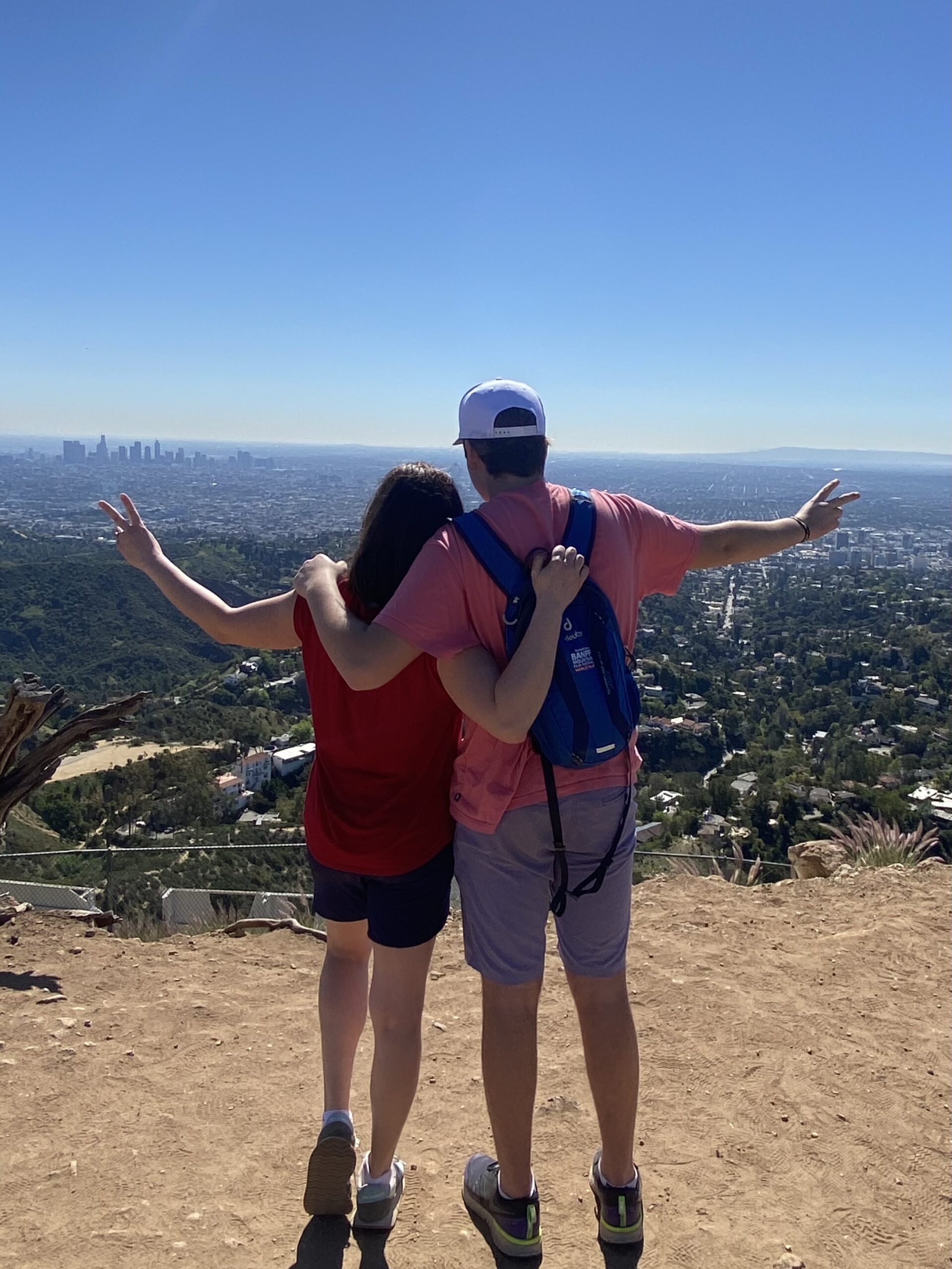 Mother and son pose at the top of the best hollywood sign tour